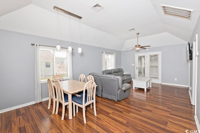 dining room featuring lofted ceiling, dark wood-style flooring, and visible vents