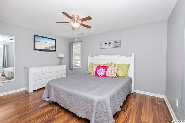 bedroom featuring wood finished floors, a ceiling fan, and baseboards