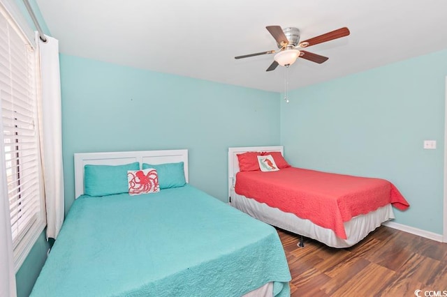 bedroom with baseboards, a ceiling fan, and wood finished floors