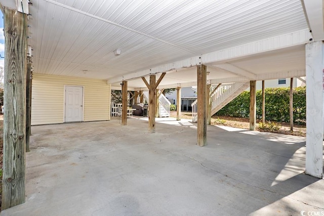 view of patio / terrace with stairway and a carport