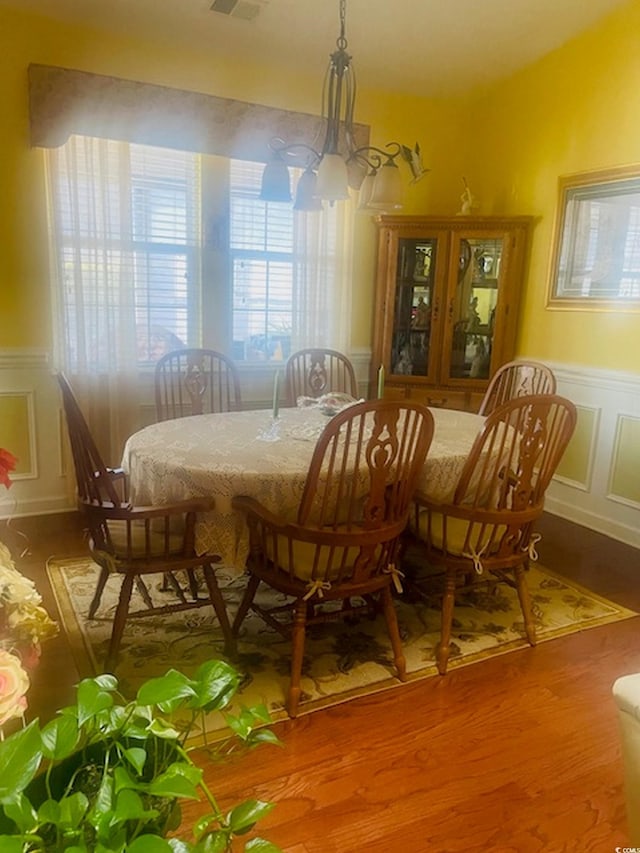 1575 Berkshire Ave, Myrtle Beach, SC 29577 - dining area with wood finished floors, wainscoting, and a decorative wall