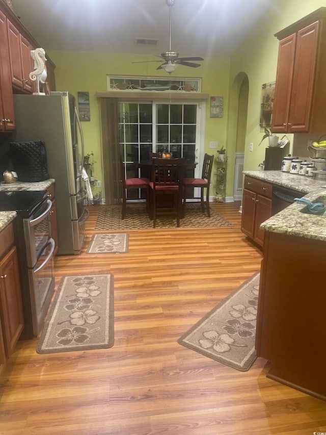 1575 Berkshire Ave, Myrtle Beach, SC 29577 - kitchen with stainless steel appliances, arched walkways, a ceiling fan, and light wood-type flooring