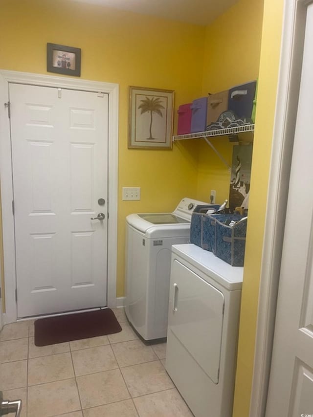 1575 Berkshire Ave, Myrtle Beach, SC 29577 - laundry area with washer and clothes dryer, light tile patterned flooring, and baseboards