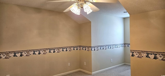 interior space featuring carpet, baseboards, ceiling fan, and a textured ceiling