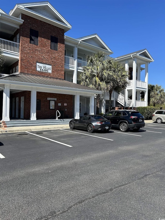 view of property featuring uncovered parking