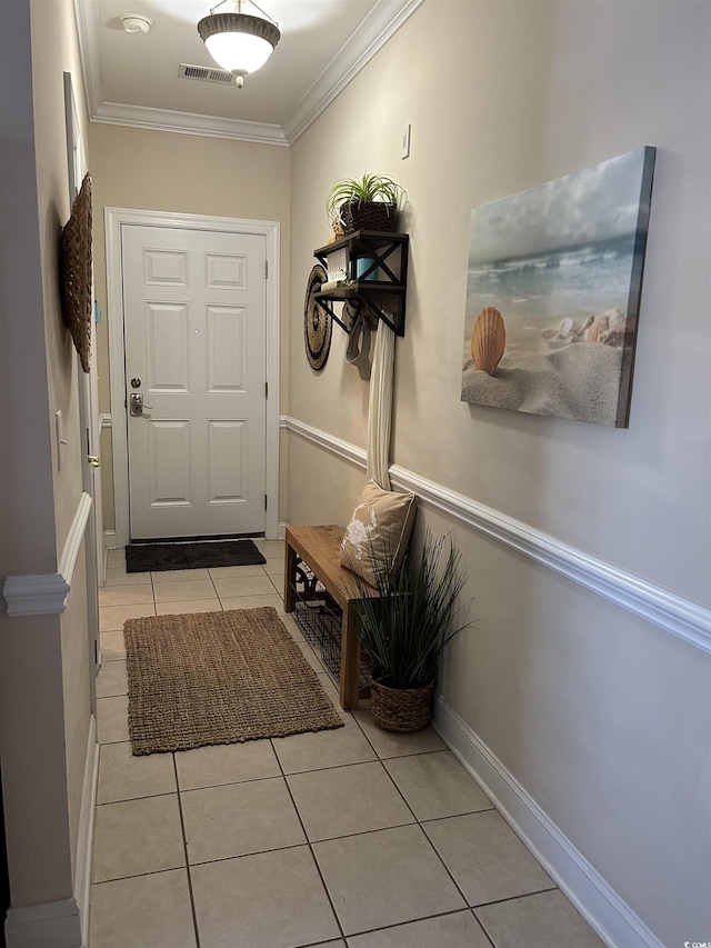 entryway featuring visible vents, ornamental molding, baseboards, and light tile patterned flooring