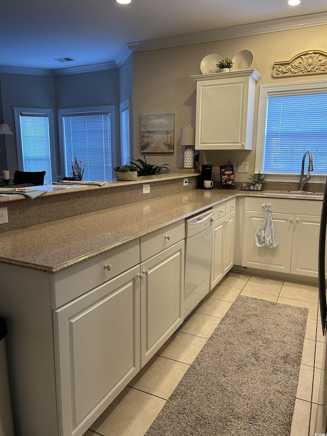 kitchen with white dishwasher, a sink, visible vents, white cabinetry, and ornamental molding