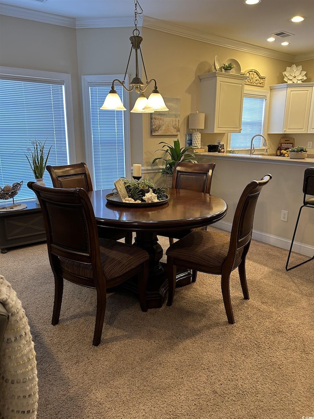 dining room featuring light carpet, ornamental molding, and visible vents