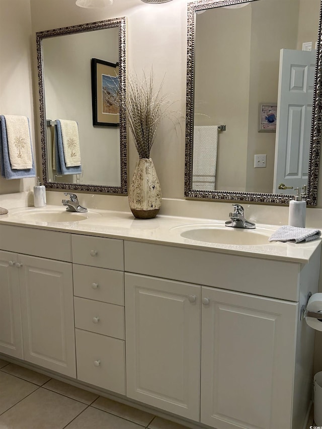 bathroom featuring double vanity, a sink, and tile patterned floors