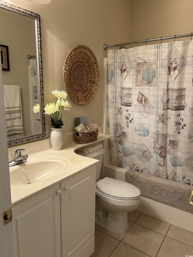 bathroom featuring toilet, tile patterned flooring, shower / tub combo with curtain, and vanity