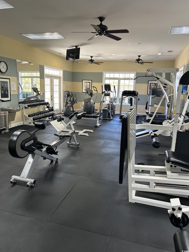 gym featuring a healthy amount of sunlight and baseboards