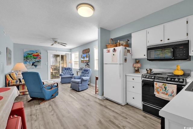 kitchen with light wood-type flooring, a textured ceiling, black appliances, and light countertops