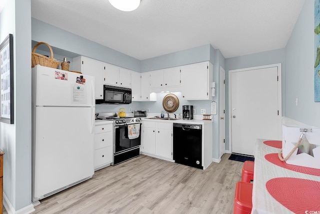 kitchen featuring black appliances, light wood-type flooring, light countertops, white cabinetry, and a sink