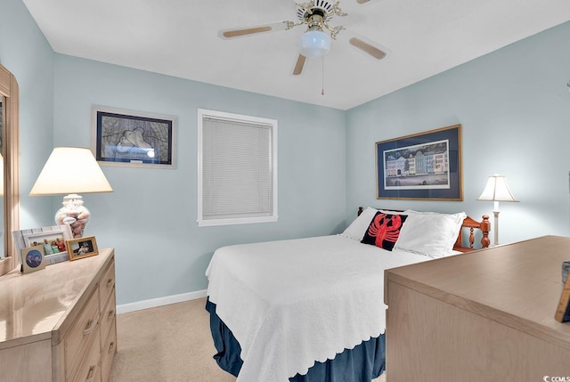 bedroom with light colored carpet, baseboards, and ceiling fan