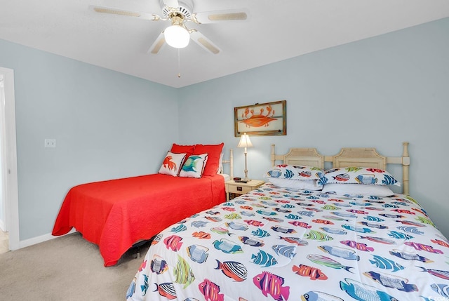 carpeted bedroom featuring baseboards and a ceiling fan