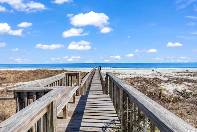 surrounding community with a beach view and a water view