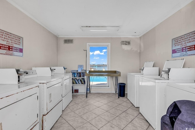 community laundry room with visible vents, crown molding, and separate washer and dryer