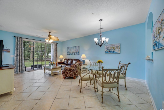 dining room featuring light tile patterned floors, a textured ceiling, ceiling fan with notable chandelier, and baseboards