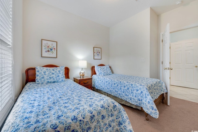 carpeted bedroom with tile patterned floors