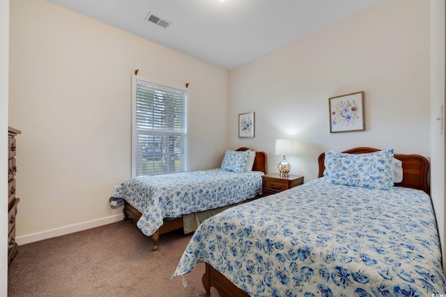 bedroom with baseboards, visible vents, and carpet flooring