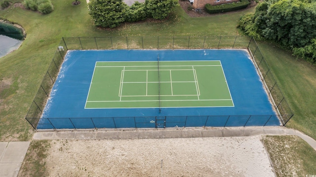 view of sport court with fence and a yard