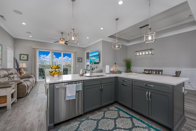 kitchen with gray cabinetry, a sink, open floor plan, light countertops, and stainless steel dishwasher