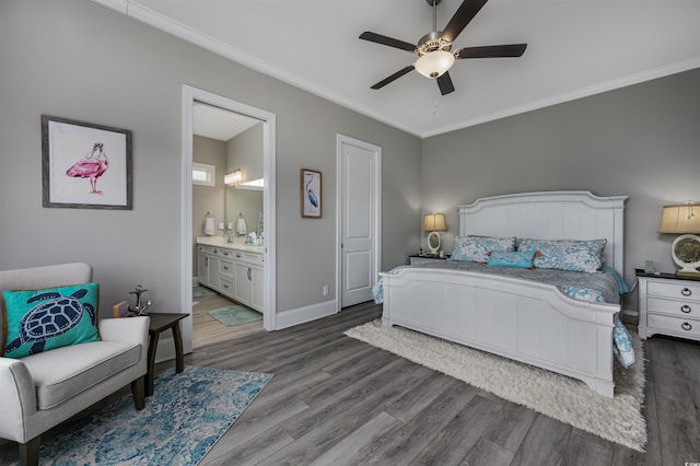 bedroom featuring baseboards, connected bathroom, ceiling fan, ornamental molding, and wood finished floors