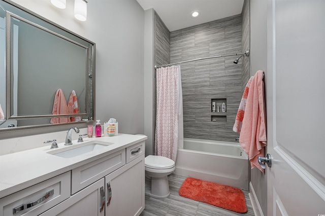 bathroom featuring vanity, toilet, and shower / tub combo with curtain