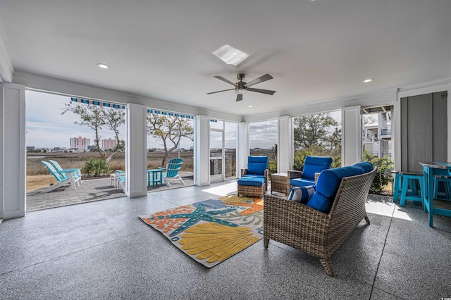 sunroom / solarium featuring ceiling fan