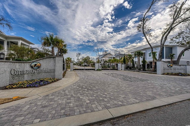 view of road with a gate, a residential view, and a gated entry