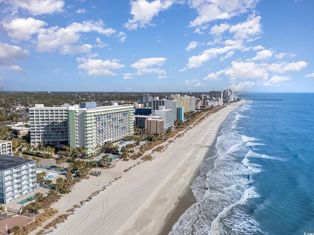 bird's eye view featuring a view of the beach, a city view, and a water view