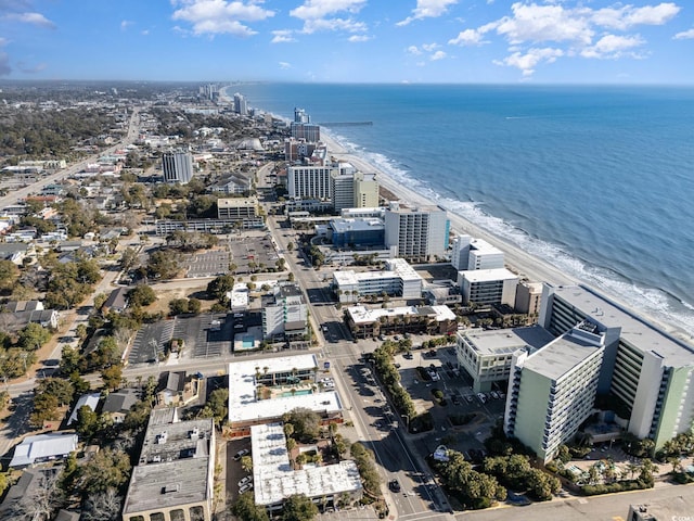 birds eye view of property with a view of city, a water view, and a beach view