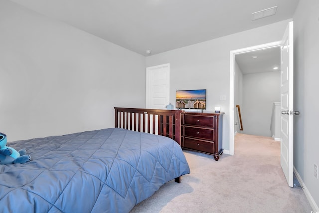 bedroom featuring light colored carpet, visible vents, and baseboards