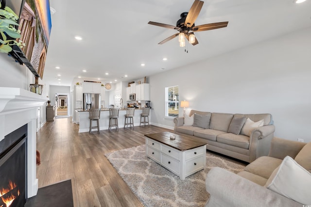 738 Harrison Mill St, Myrtle Beach, SC 29579 - living area featuring a warm lit fireplace, a ceiling fan, light wood-type flooring, recessed lighting, and baseboards