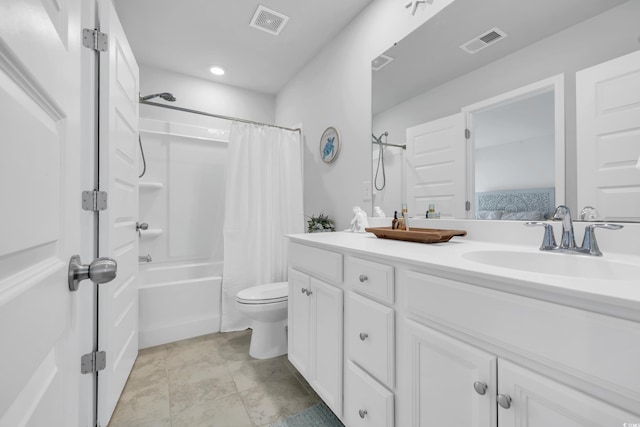 bathroom featuring visible vents, a sink, toilet, and double vanity