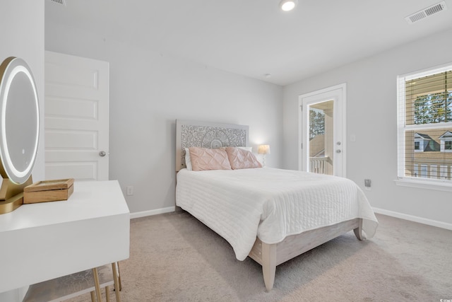 bedroom with light carpet, access to exterior, baseboards, and visible vents