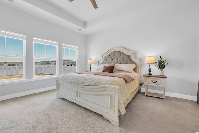 carpeted bedroom with a ceiling fan, visible vents, and baseboards