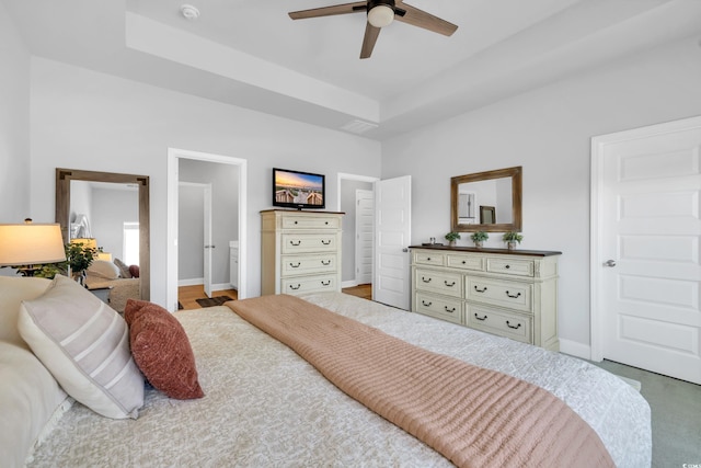 bedroom featuring ceiling fan, baseboards, and a raised ceiling