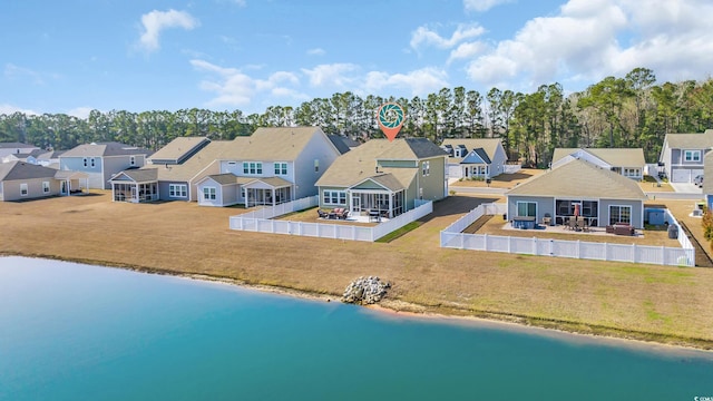 birds eye view of property with a water view and a residential view