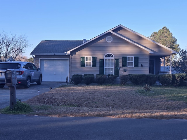 single story home with driveway and an attached garage