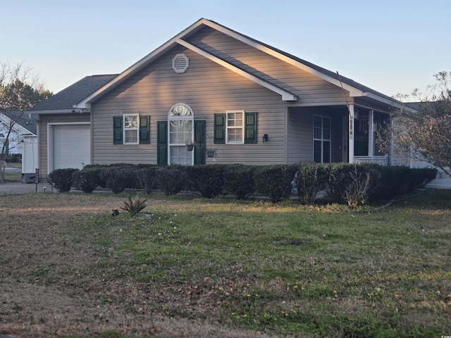 view of front of property with a garage and a front lawn