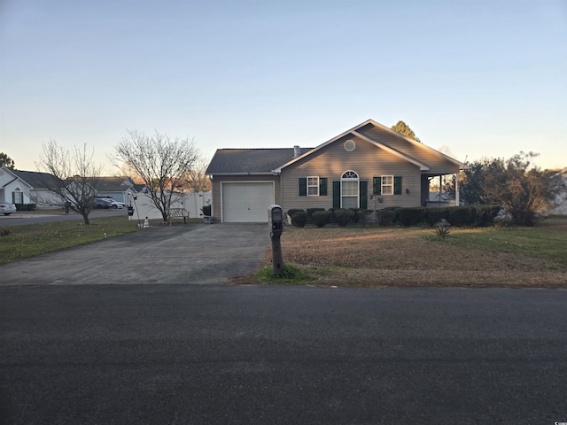 view of front of house featuring aphalt driveway and an attached garage