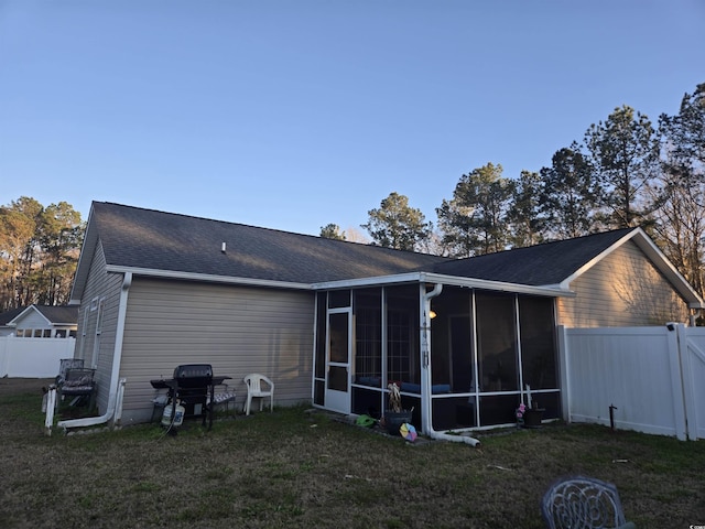 9903 Conifer Ln, Murrells Inlet, SC 29576 - back of property featuring fence, a yard, a shingled roof, and a sunroom