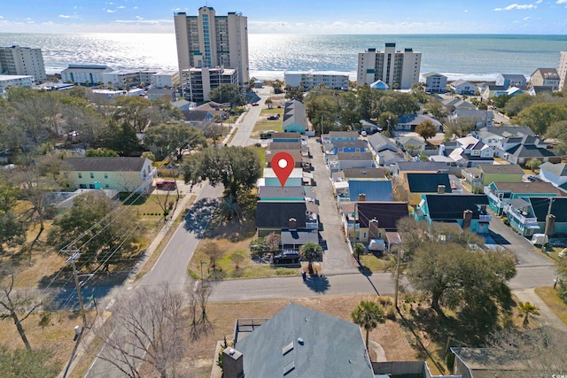 birds eye view of property featuring a view of city and a water view