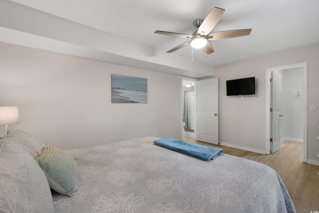 bedroom with a ceiling fan, baseboards, and wood finished floors