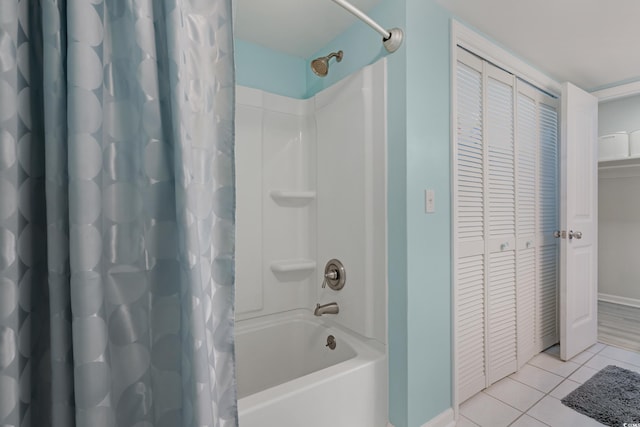 bathroom featuring shower / bath combination with curtain, tile patterned flooring, a closet, and baseboards