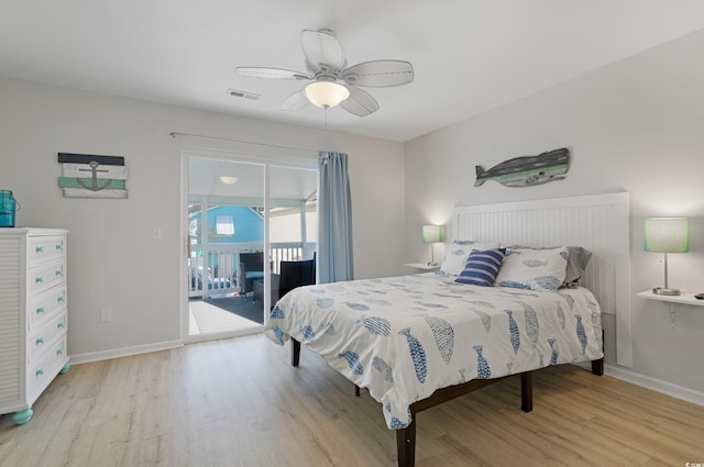 bedroom with access to exterior, visible vents, baseboards, and wood finished floors