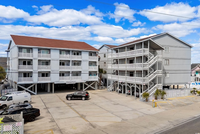 view of building exterior with uncovered parking