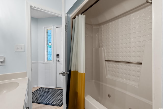 bathroom with vanity, shower / tub combo with curtain, and wood finished floors