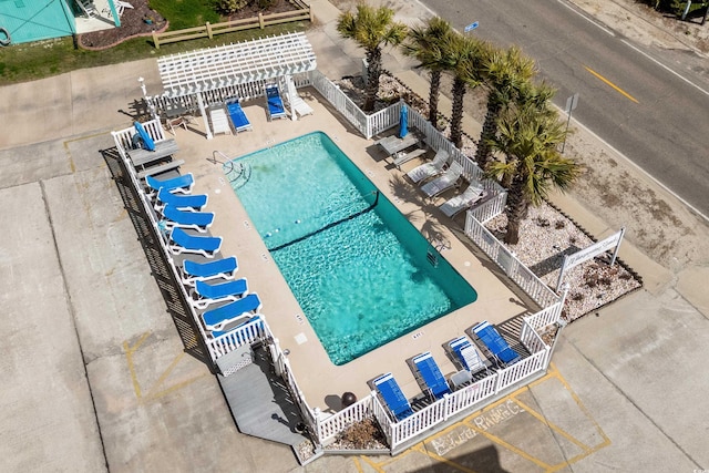 pool featuring fence, a water slide, and a patio area